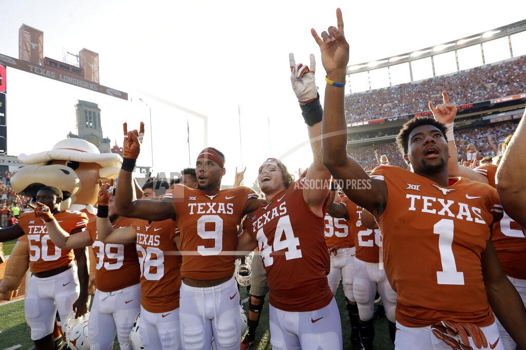 Eric Gay Texas wide receiver Collin Johnson (9) and defensive lineman Breckyn Hager (44) celebrate their win over Baylor with teammates after an NCAA college football game, Saturday, Oct. 13, 2018, in Austin, Texas. (AP Photo/Eric Gay)