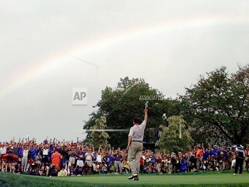 Elise Amendola File - A rainbow soars above Davis Love III, of Sea Island, Ga., after he won the PGA Championship at Winged Foot Golf Club in Mamaroneck, N.Y., August 17, 1997. Love won his only major 25 years ago. (AP Photo/Elise Amendola, File )