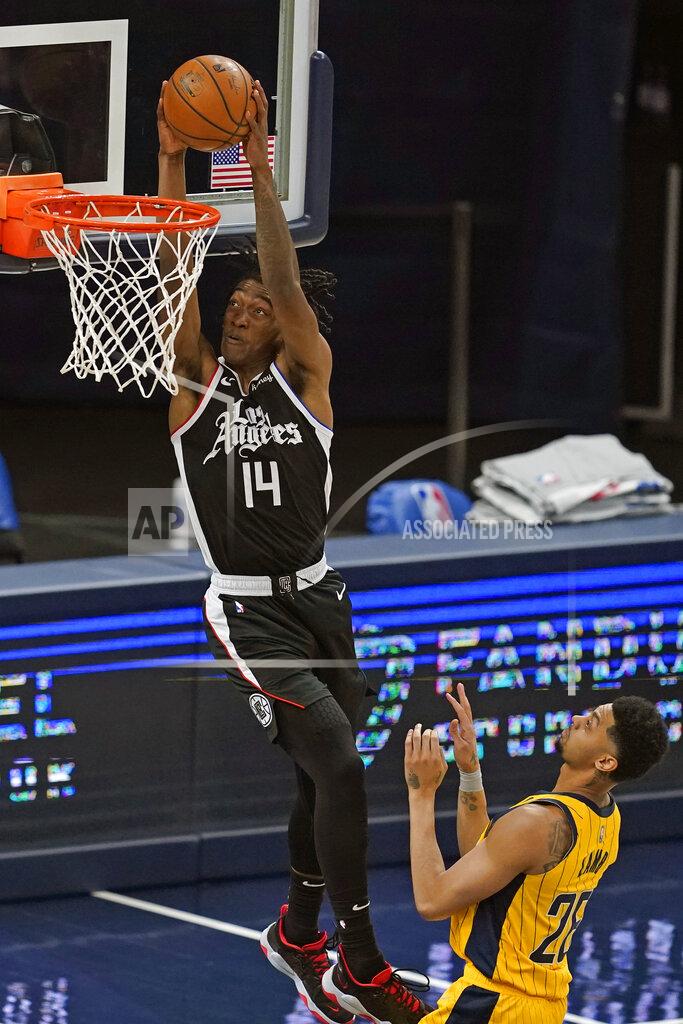 Darron Cummings Los Angeles Clippers' Terance Mann (14) dunks against Indiana Pacers' Jeremy Lamb (26) during the second half of an NBA basketball game, Tuesday, April 13, 2021, in Indianapolis. (AP Photo/Darron Cummings)