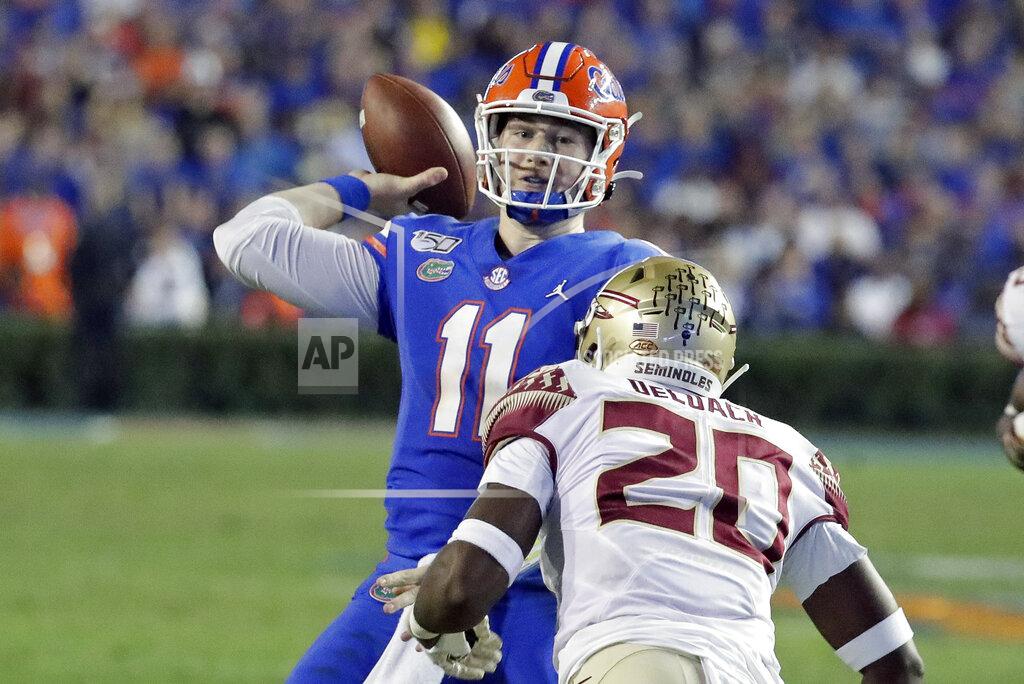 John Raoux Florida quarterback Kyle Trask (11) throws a pass over Florida State linebacker Kalen DeLoach (20) during the first half of an NCAA college football game Saturday, Nov. 30, 2019, in Gainesville, Fla. (AP Photo/John Raoux)