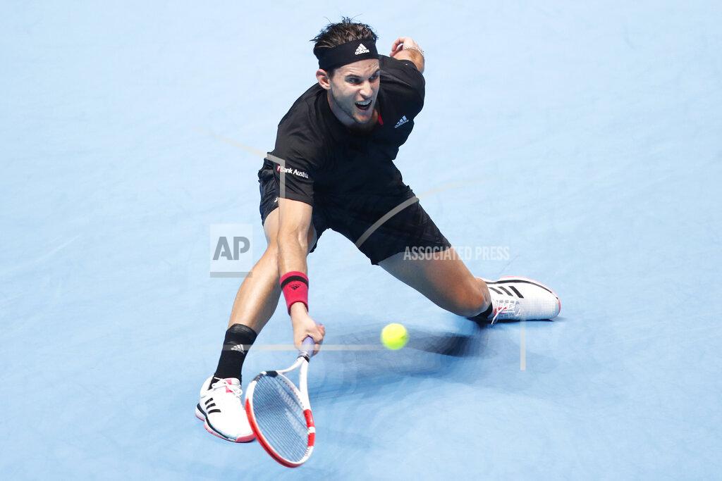 Frank Augstein Dominic Thiem of Austria plays a return to Daniil Medvedev of Russia during their singles final tennis match at the ATP World Finals tennis tournament at the O2 arena in London, Sunday, Nov. 22, 2020. (AP Photo/Frank Augstein)