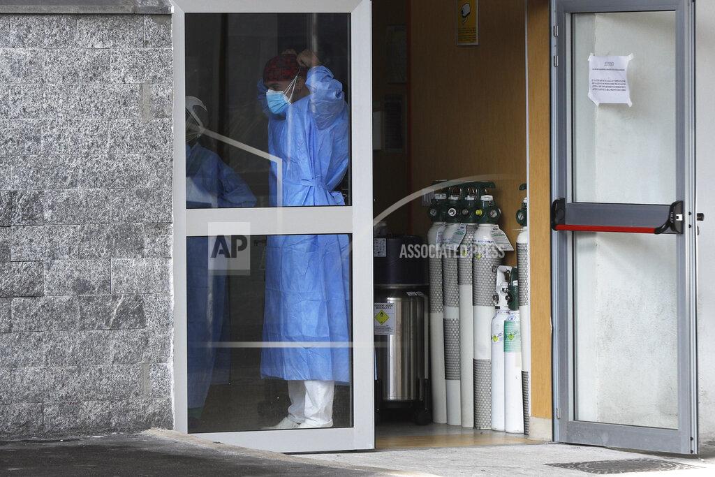 Gregorio Borgia Oxygen canister sit near the entrance of the first aid department of the Cardarelli hospital in Naples, Italy, Friday, Nov. 13, 2020. Outside the ER entrance of Cardarelli, the main health care facility for densely populated Naples, those desperate for oxygen for loved ones lined up in their cars, waiting for nurses to bring tanks of the life-saving element. (AP Photo/Gregorio Borgia)