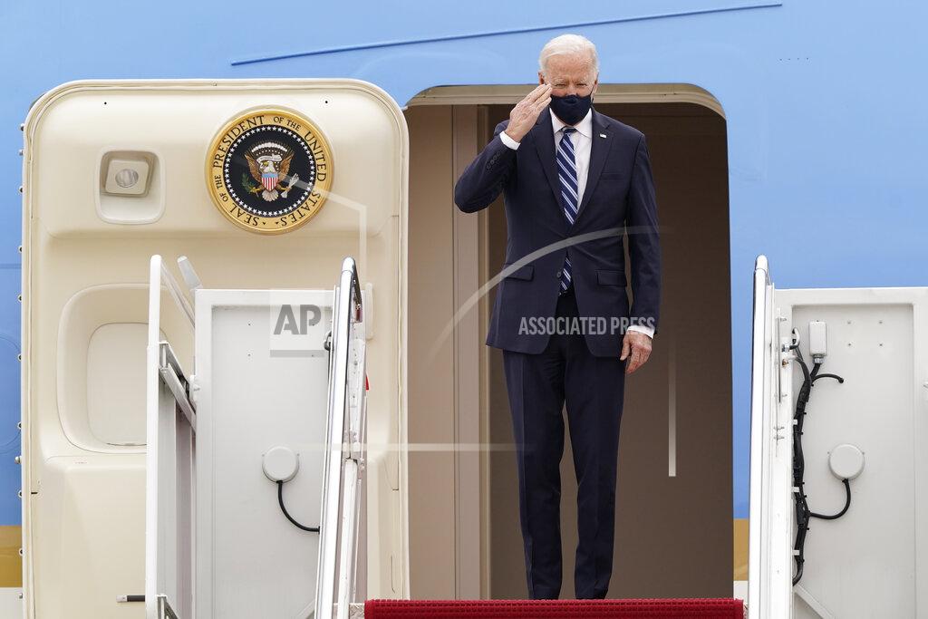 Susan Walsh President Joe Biden salutes from the top of the steps of Air Force One at Andrews Air Force Base, Md., Tuesday, March 16, 2021, as he prepares to depart for a trip to Pennsylvania. (AP Photo/Susan Walsh)