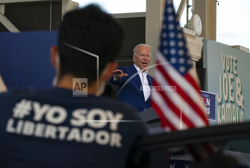 Carolyn Kaster Democratic presidential candidate former Vice President Joe Biden speaks at Miramar Regional Park in Miramar, Fla., Tuesday Oct. 13, 2020, as supporters watch from their cars. (AP Photo/Carolyn Kaster)