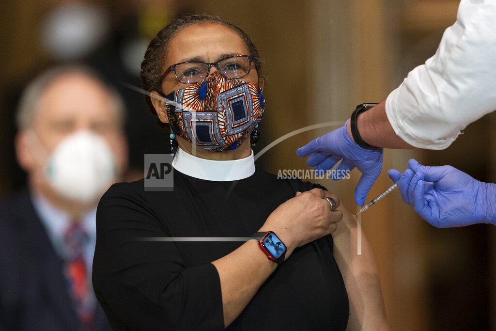 Rev. Patricia Hailes Fears, pastor of the Fellowship Baptist Church in Washington, is administered with the Johnson & Johnson COVID-19 vaccine during a gathering of a group of interfaith clergy members, community leaders and officials at the Washington National Cathedral, to encourage faith communities to get the COVID-19 vaccine, Tuesday, March 16, 2021, in Washington. (AP Photo/Manuel Balce Ceneta)