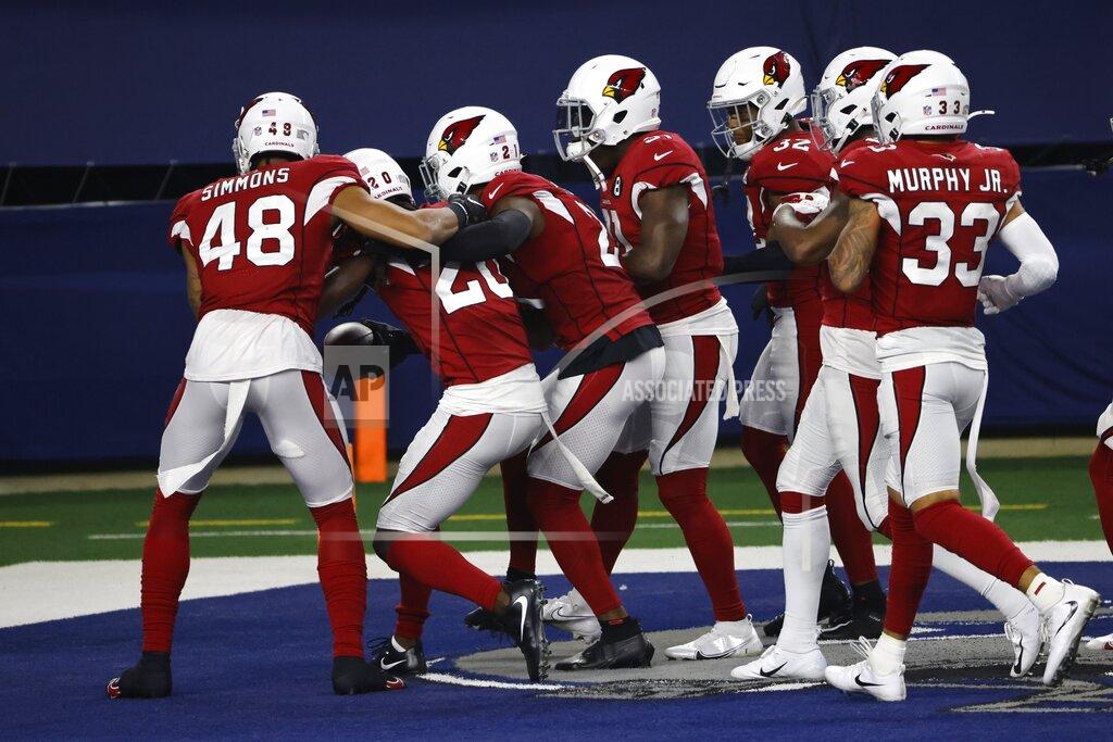 Ron Jenkins Arizona Cardinals' Isaiah Simmons (48) and others celebrate with Dre Kirkpatrick, second from left, after Kirkpatrick intercepted a pass thrown by Dallas Cowboys' Andy Dalton in the second half of an NFL football game in Arlington, Texas, Monday, Oct. 19, 2020. (AP Photo/Ron Jenkins)