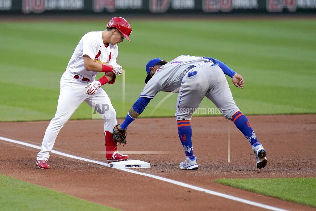Jeff Roberson St. Louis Cardinals' Tommy Edman, left, arrives at third for a triple ahead of the tag from New York Mets third baseman Jonathan Villar during the first inning of a baseball game Monday, May 3, 2021, in St. Louis. (AP Photo/Jeff Roberson)