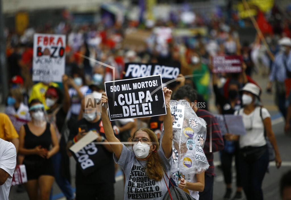 Bruna Prado A woman wearing a protective face mask holds a sign with a message that reads in Portuguese; "500 k deaths! His fault!" during a protest against Brazilian President Jair Bolsonaro's handling of the coronavirus pandemic and economic policies they say harm the interests of the poor and working class, in Rio de Janeiro, Brazil, Saturday, June 19, 2021. Brazil is approaching an official COVID-19 death toll of 500,000 — second-highest in the world. (AP Photo/Bruna Prado)