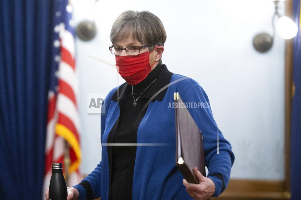 Gov. Laura Kelly walks out of a press conference at the Statehouse where she issued a face mask protocol in an executive order, Wednesday, Nov. 18, 2020, in Topeka, Kan. (Evert Nelson/The Topeka Capital-Journal via AP)