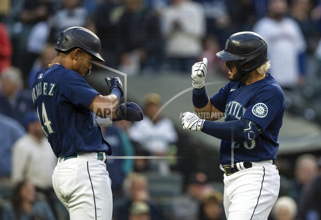 Stephen Brashear Seattle Mariners' Eugenio Suarez, right, celebrates with teammate Julio Rodriguez after hitting a two-run home run off Oakland Athletics starting pitcher Zach Logue during the fifth inning of a baseball game, Monday, May 23, 2022, in Seattle. Rodriguez also scored on the hit. (AP Photo/Stephen Brashear)