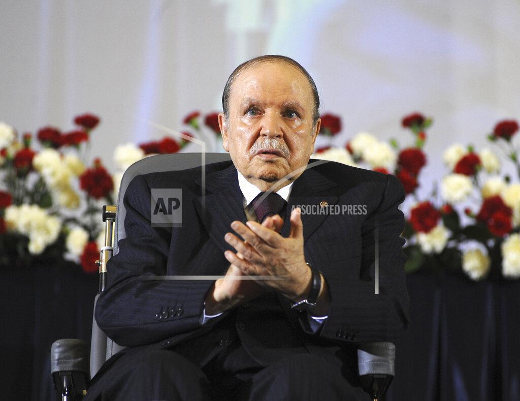 Sidali Djarboub FILE - In this April 28, 2014, file photo, Algerian President Abdelaziz Bouteflika, sitting in a wheelchair, applauds after taking the oath as President in Algiers. Former Algerian President Bouteflika, who fought for independence from France in the 1950s and 1960s and was ousted amid pro-democracy protests in 2019 after 20 years in power, has died at age 84, state television announced Friday, Sept. 17, 2021. (AP Photo/Sidali Djarboub, File)