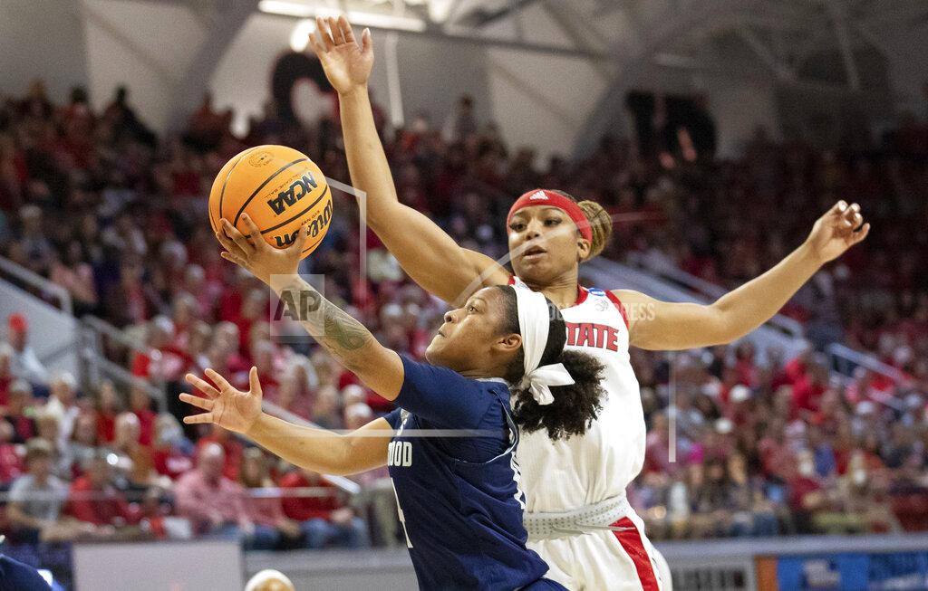 Ben Mckeown Longwood's Tra'Dayja Smith, left, attempts a shot ahead of North Carolina State's Kai Crutchfield, right, during the first half of a college basketball game in the first round of the NCAA tournament in Raleigh, N.C., Saturday, March 19, 2022. (AP Photo/Ben McKeown)
