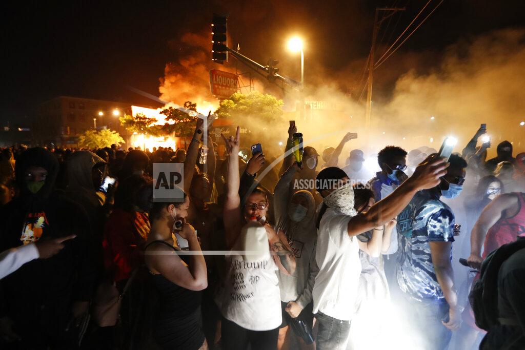 John Minchillo Protesters gather in front of the burning 3rd Precinct building of the Minneapolis Police Department on Thursday, May 28, 2020, in Minneapolis. Protests over the death of George Floyd, a black man who died in police custody Monday, broke out in Minneapolis for a third straight night. (AP Photo/John Minchillo)