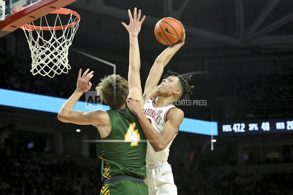 Michael Woods Arkansas forward Trevon Brazile, right, is fouled by North Dakota State guard forward Grant Nelson (4) as he goes up for a dunk during the second half of an NCAA college basketball game Monday, Nov. 7, 2022, in Fayetteville, Ark. (AP Photo/Michael Woods)