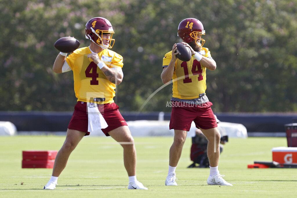 Ryan M. Kelly Washington Football Team quarterbacks Taylor Heinicke (4) and Ryan Fitzpatrick (14) throw passes during NFL football practice in Richmond, Va., Wednesday, July 28, 2021. (AP Photo/Ryan M. Kelly)
