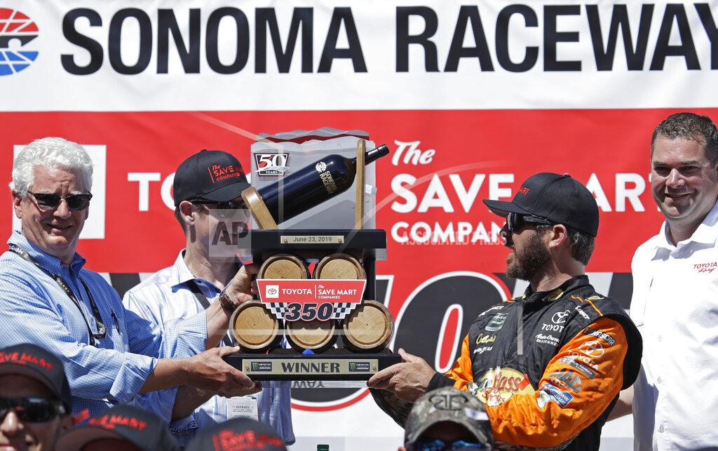 Ben Margot Martin Truex Jr., third from left, celebrates after winning a NASCAR Sprint Cup Series auto race Sunday, June 23, 2019, in Sonoma, Calif. (AP Photo/Ben Margot)