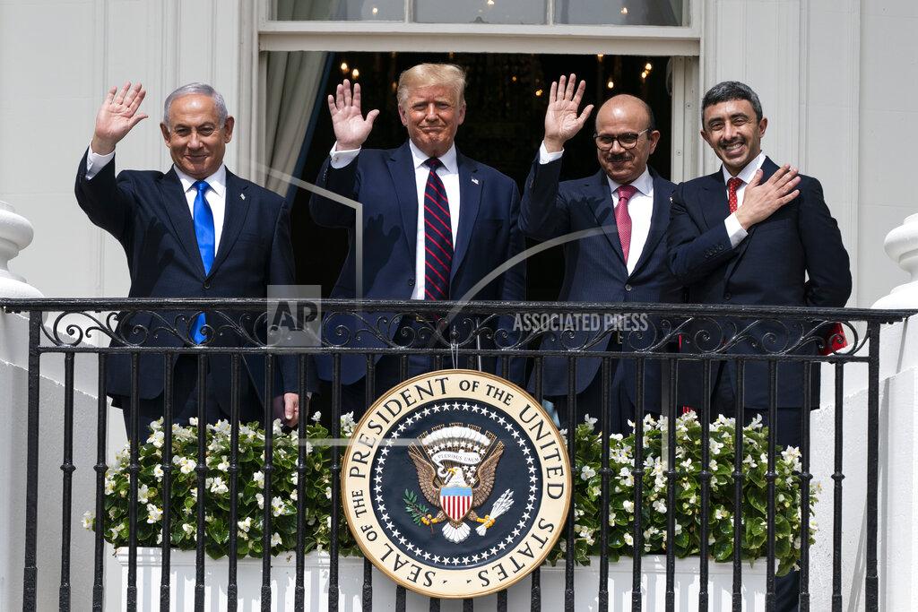 Alex Brandon Israeli Prime Minister Benjamin Netanyahu, left, President Donald Trump, Bahrain Foreign Minister Khalid bin Ahmed Al Khalifa and United Arab Emirates Foreign Minister Abdullah bin Zayed al-Nahyan react on the Blue Room Balcony after signing the Abraham Accords during a ceremony on the South Lawn of the White House, Tuesday, Sept. 15, 2020, in Washington. (AP Photo/Alex Brandon)