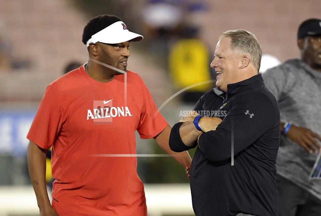 Mark J. Terrill Arizona head coach Kevin Sumlin, left, talks with UCLA head coach Chip Kelly prior to an NCAA college football game, Saturday, Oct. 20, 2018, in Pasadena, Calif. (AP Photo/Mark J. Terrill)