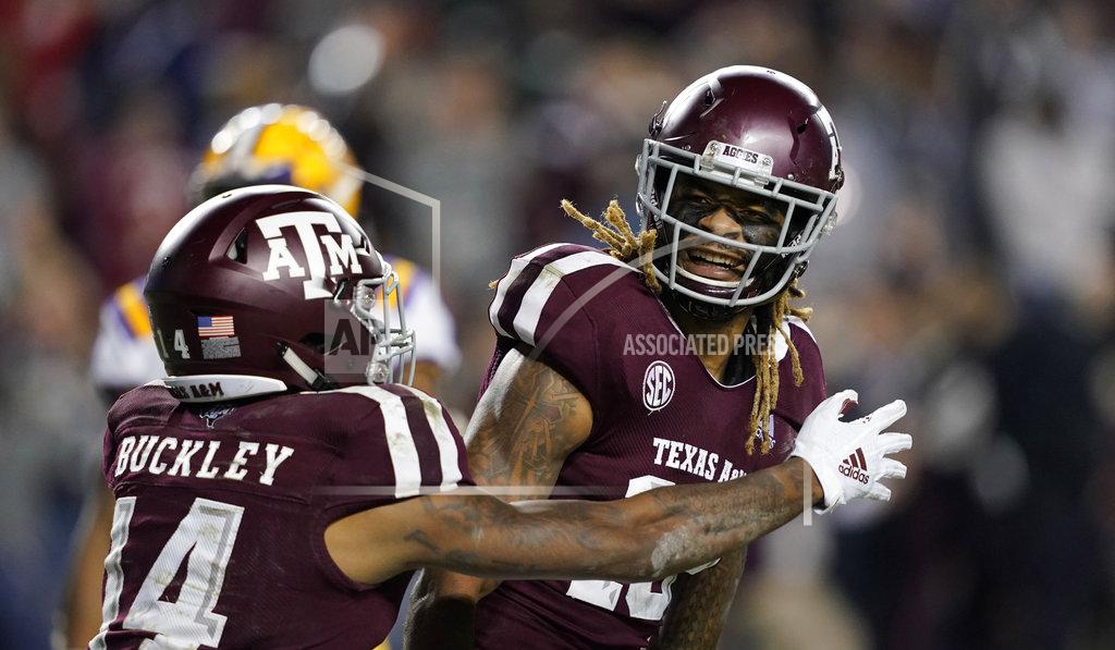 David J. Phillip Texas A&M wide receiver Kendrick Rogers, right, celebrates with Camron Buckley (14) after catching a pass for a two-point conversion during the seventh overtime of an NCAA college football game against LSU Saturday, Nov. 24, 2018, in College Station, Texas. Texas A&M won 74-72. (AP Photo/David J. Phillip)