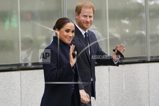 Meghan Markle and Prince Harry pose for pictures after visiting the observatory in One World Trade in New York, Thursday, Sept. 23, 2021. The Duke and Duchess of Sussex got a hawk's-eye view of New York City with a visit to the rebuilt World Trade Center's signature tower. (AP Photo/Seth Wenig)