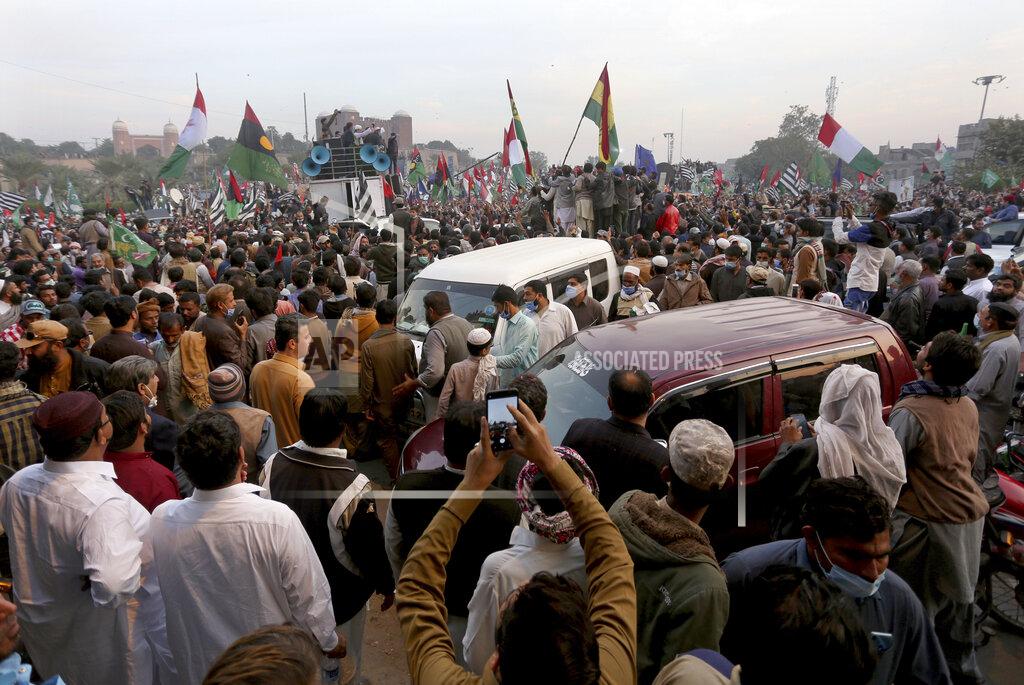 Asim Tanveer Supporters of the Pakistan Democratic Movement, an alliance of opposition parties, attend an anti-government rally, in Multan, Pakistan, Monday, Nov. 30, 2020. Despite a government ban and arrests of hundreds of activists, Pakistani opposition supporters rallied in a central city on Monday, calling on Prime Minister Imran Khan to resign over alleged bad governance and incompetence. (AP Photo/Asim Tanveer)