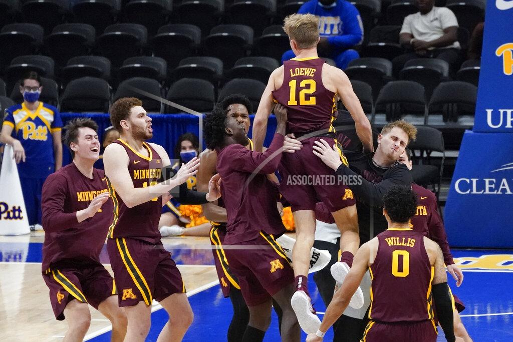 Keith Srakocic Minnesota's Luke Loewe (12) is hoisted by teammates after Minnesota defeated Pittsburgh 54-53 in an NCAA college basketball game, Tuesday, Nov. 30, 2021, in Pittsburgh. Loewe scored the go-ahead basket in the closing seconds. (AP Photo/Keith Srakocic)