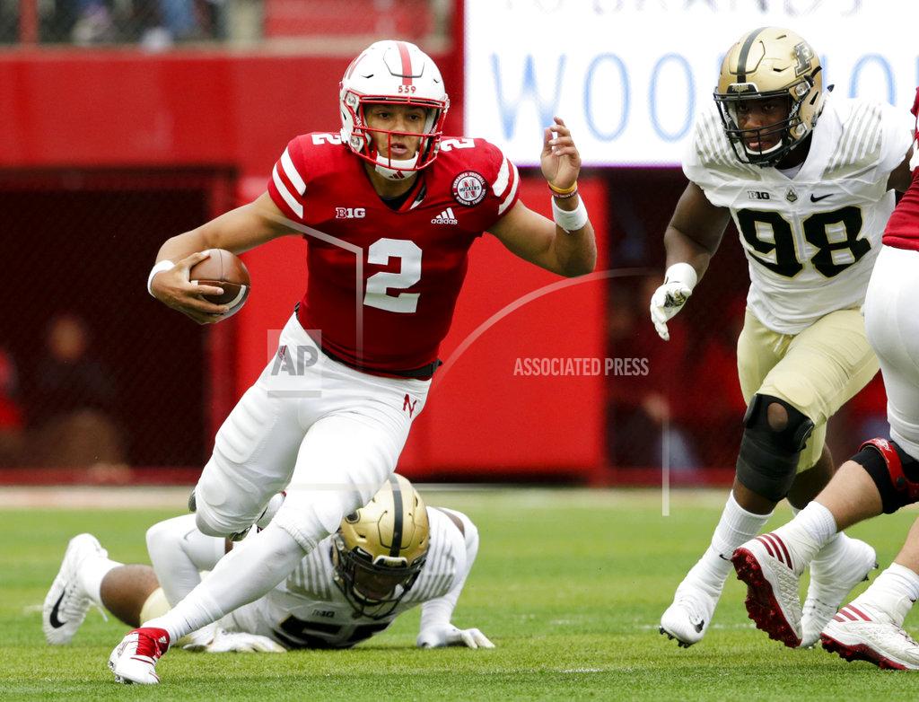 Nati Harnik FIJLE - In this Sept. 29, 2018, file photo, Nebraska quarterback Adrian Martinez (2) carries the ball away from Purdue linebacker Derrick Barnes (55) and defensive end Kai Higgins (98) during the first half of an NCAA college football game in Lincoln, Neb. Four starts into his career, Martinez already is showing signs of blossoming into the next standout quarterback coached by Scott Frost. (AP Photo/Nati Harnik, File)