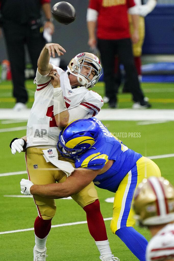 Alex Gallardo San Francisco 49ers quarterback Nick Mullens, left, is hit as he throws by Los Angeles Rams defensive tackle Greg Gaines during the second half of an NFL football game Sunday, Nov. 29, 2020, in Inglewood, Calif. (AP Photo/Alex Gallardo)