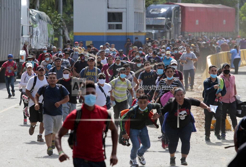 Uncredited Migrants attempt to cross the border from Corinto, Honduras, into Corinto, Guatemala, Thursday, Oct. 1, 2020. Hundreds of migrants walked from San Pedro Sula, Honduras to the Guatemala border, testing a well-trod migration route now in times of the new coronavirus. (AP Photo)