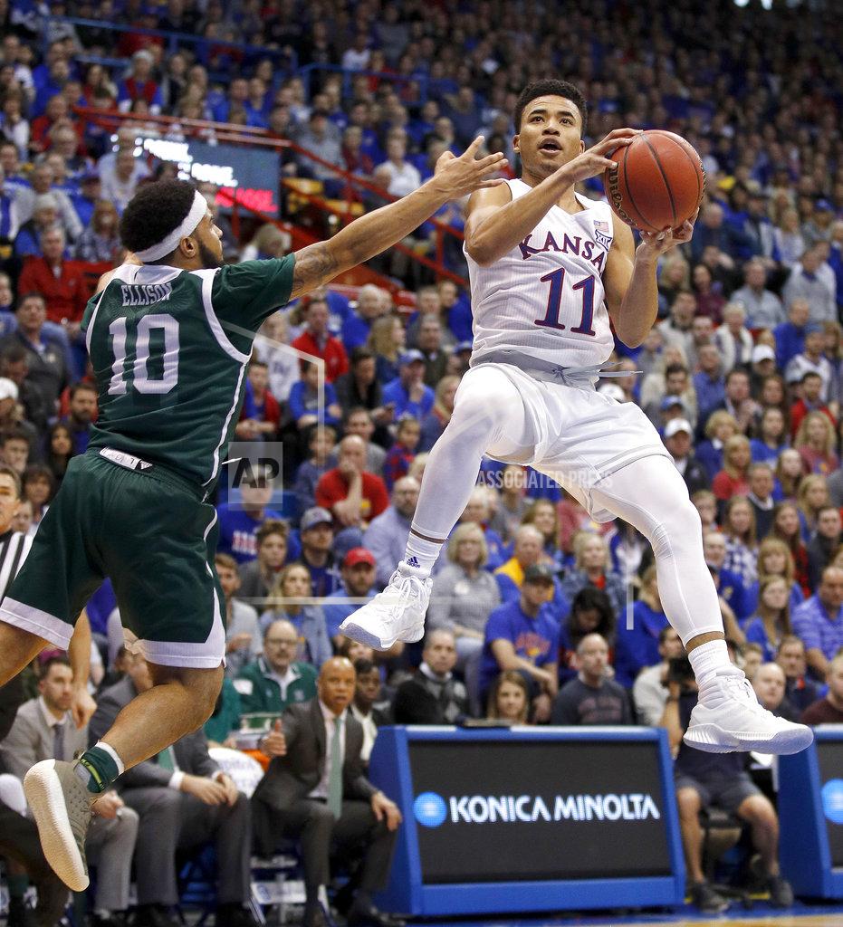 Charlie Riedel Kansas' Devon Dotson (11) shoots under pressure from Eastern Michigan's Malik Ellison (10) during the first half of an NCAA college basketball game Saturday, Dec. 29, 2018, in Lawrence, Kan. (AP Photo/Charlie Riedel)