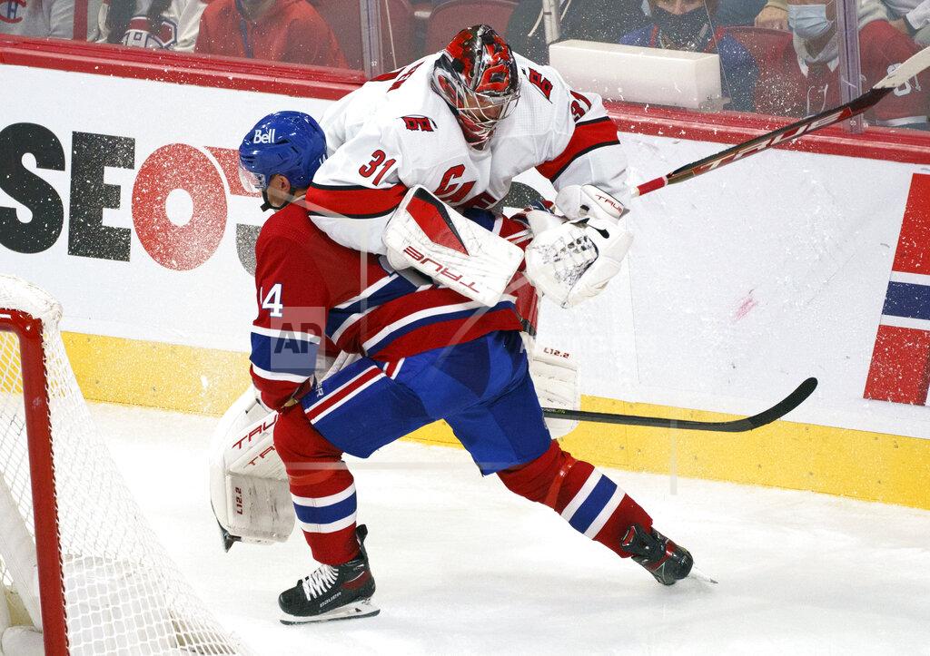Paul Chiasson Montreal Canadiens' Nick Suzuki runs into Carolina Hurricanes goaltender Frederik Andersen behind the net during the second period of an NHL hockey game Thursday, Oct. 21, 2021, in Montreal. (Paul Chiasson/The Canadian Press via AP)