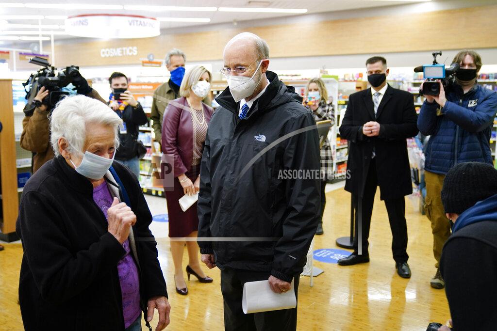 Matt Rourke Pennsylvania, Gov. Tom Wolf speaks with Darlene Morris, 83, as she waits to receive a COVID-19 vaccination at a Rite-Aid pharmacy in Steelton, Pa., Friday, March 5, 2021. (AP Photo/Matt Rourke)