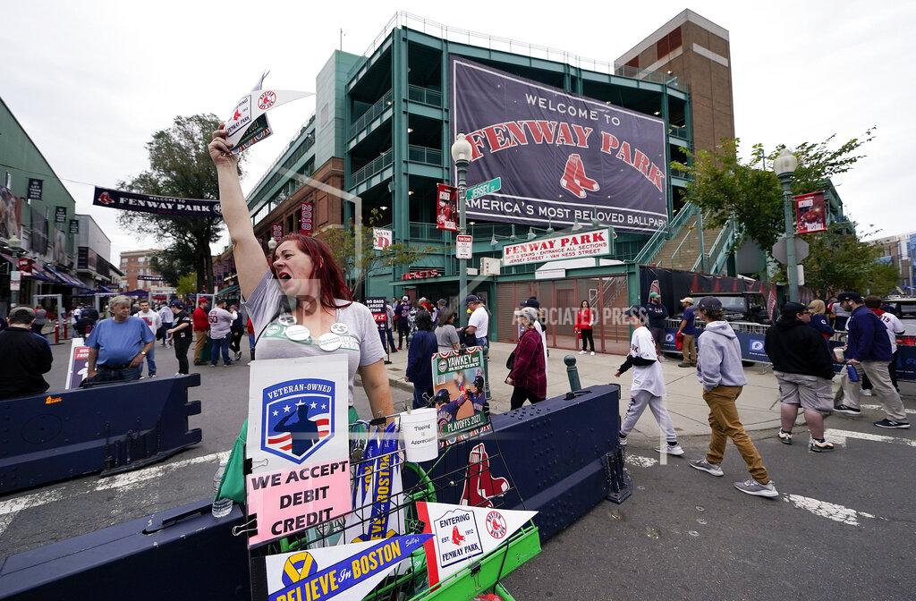 Charles Krupa Vendor Patricia Almquist, of North Oxford, Mass., sells souvenirs outside Fenway Park before game 3 of a baseball American League Division Series between the Boston Red Sox and the Tampa Bay Rays, Sunday, Oct. 10, 2021, in Boston. (AP Photo/Charles Krupa)