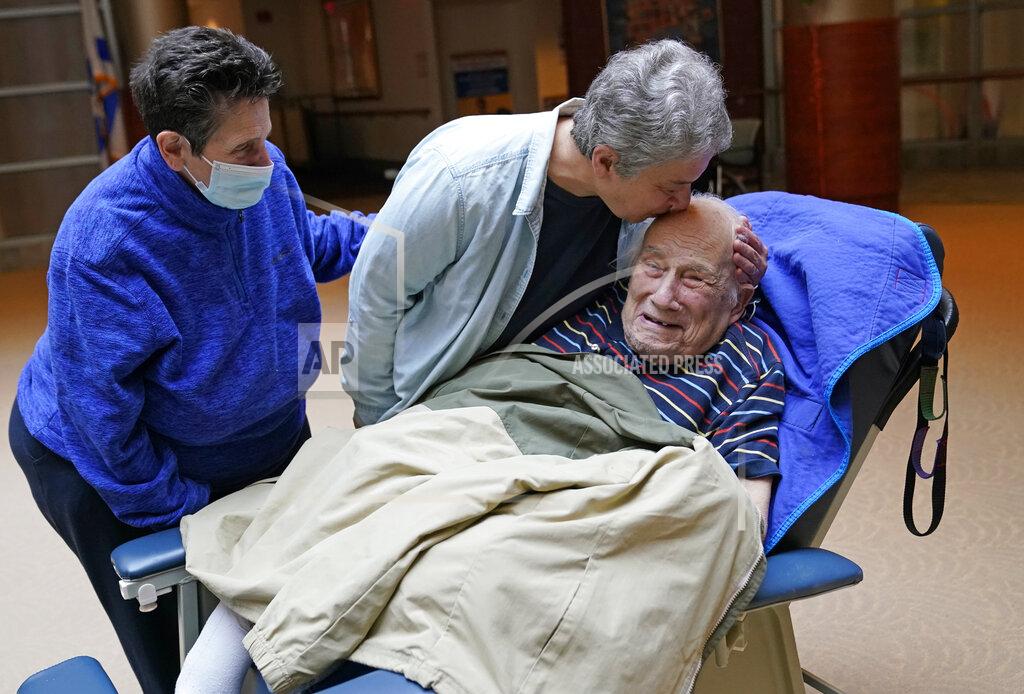 Kathy Willens FILE - Melvin Goldstein, 90, smiles as his daughter Barbara Goldstein gives him a kiss on the head during their first in-person, indoor family visit inside the Hebrew Home at Riverdale, Sunday, March 28, 2021, in the Bronx borough of New York. A focus on the elderly at the start of the nation's vaccination campaign helped protect nursing homes that were ravaged at the height of the U.S. coronavirus outbreak, but they are far from in the clear. New outbreaks, often traced to infected staff members, are still occurring in long-term care centers across the country, causing continued havoc for visitation policies. (AP Photo/Kathy Willens)
