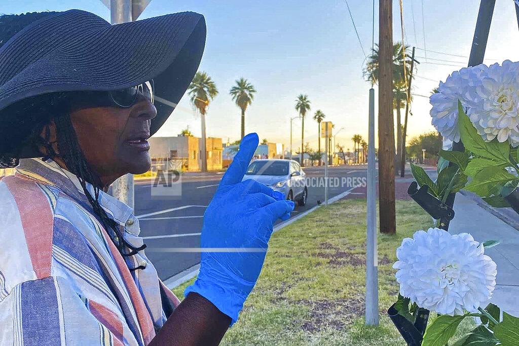 Elizabeth Veneable Elisheyah M., 61, who had been homeless for about a year when the pandemic started, gestures while speaking in Phoenix on May 25, 2020. She was couch-surfing prior to moving into a sanctioned outdoor encampment, located on a parking lot near downtown Phoenix. She hopes to move to a hotel room in the future. Homeless people are among the most vulnerable populations in the COVID-19 pandemic, yet they're largely invisible victims. (Elizabeth Veneable and the Howard Center For Investigative Journalism via AP)