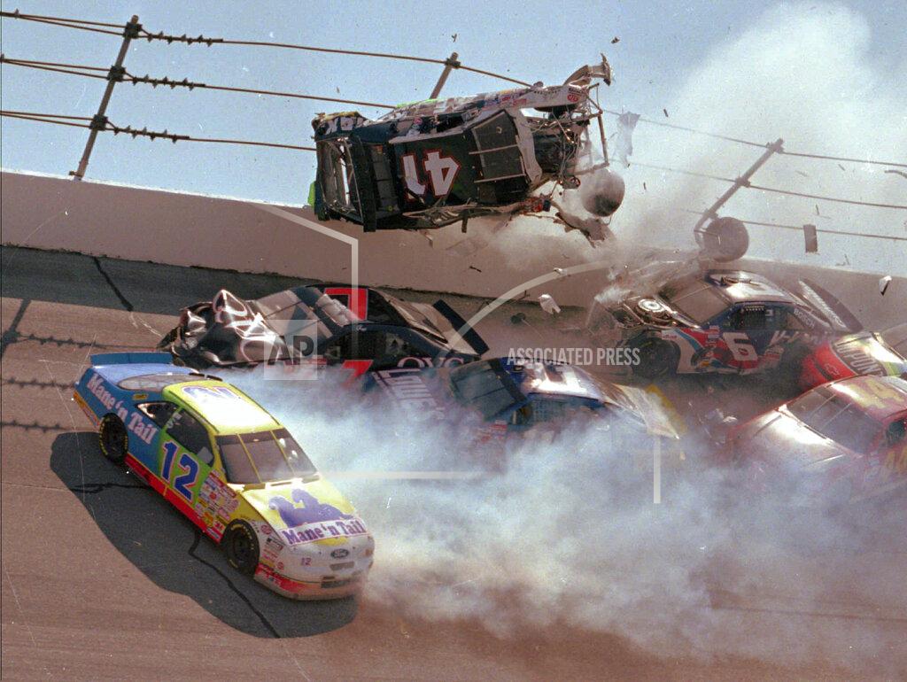 Ashley Fleming FILE - In this April 28, 1996, file photo, NASCAR driver Ricky Craven (41) flips into the catchfence in turn one of the Talladega Superspeedway during the Winston Select 500, in Talladega, Ala. Also visible are Derrike Cope (12), Geoff Bodine (7), Brett Bodine (11), Jeff Gordon (24), and Jeff Purvis (44). The ever-present air of unpredictability at Talladega Superspeedway is even more pronounced than usual this weekend, with NASCAR having replaced the horsepower-sapping restrictor plates. (AP Photo/Ashley Fleming, File)