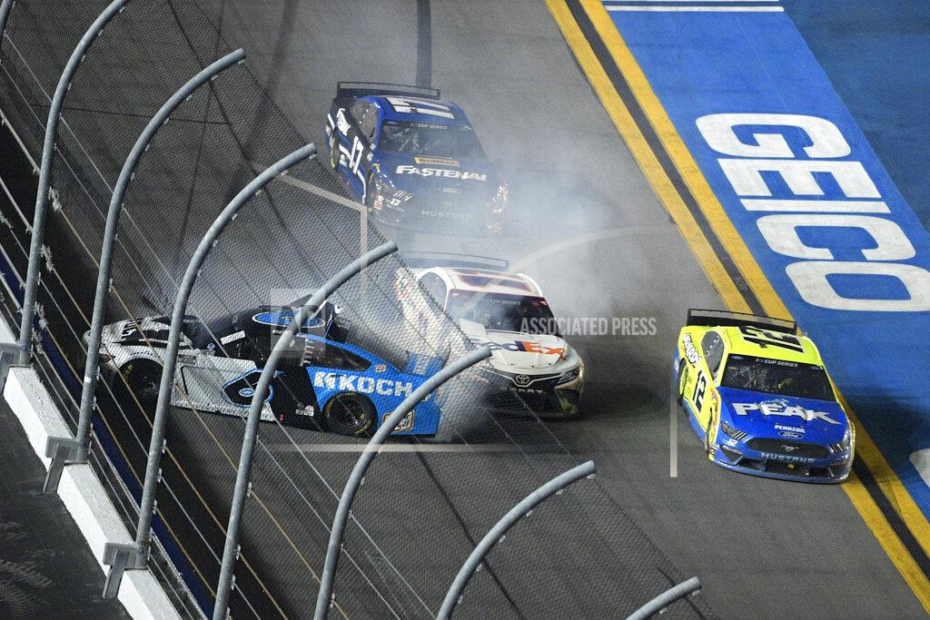 Phelan M. Ebenhack Denny Hamlin (11) squeezes between Ryan Newman (6) and Ryan Blaney (12) along the front stretch to win the NASCAR Daytona 500 auto race at Daytona International Speedway, Monday, Feb. 17, 2020, in Daytona Beach, Fla. (AP Photo/Phelan M. Ebenhack)