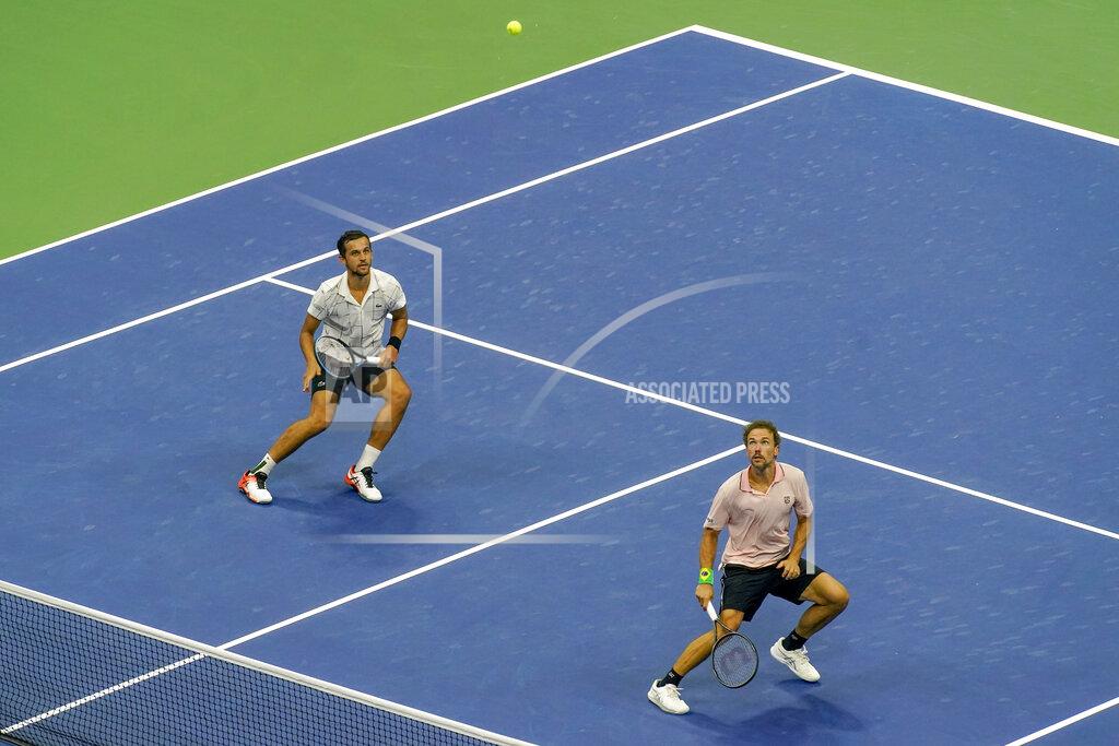 Seth Wenig Mate Pavic, of Croatia, left, and Bruno Soares, of Brazil, chase down a shot from Wesley Koolhof, of the Netherlands, and Nikola Mektic, of Croatia, during the men's doubles final of the U.S. Open tennis championships, Thursday, Sept. 10, 2020, in New York. (AP Photo/Seth Wenig)