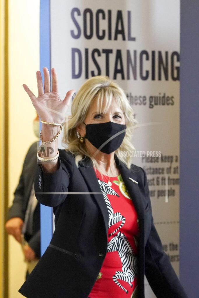 Rogelio V. Solis First lady Jill Biden waves to assembled local media as she makes her way past COVID education posters during a visit to vaccination site at Jackson State University in Jackson, Miss., Tuesday, June 22, 2021, as part of the Biden administration's nationwide tour to reach Americans who haven't been vaccinated and to promote vaccine education. (AP Photo/Rogelio V. Solis)