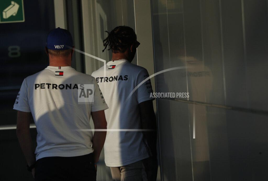 Pavel Golovkin Mercedes driver Lewis Hamilton of Britain, right, and Mercedes driver Valtteri Bottas of Finland, left, walk together after attending a media conference prior to the Russian Formula One Grand Prix, at the Sochi Autodrom circuit, in Sochi, Russia, Thursday, Sept. 24, 2020. The Russian Formula One Grand Prix will take place on Sunday, Sept. 27, 2020. (AP Photo/Pavel Golovkin)