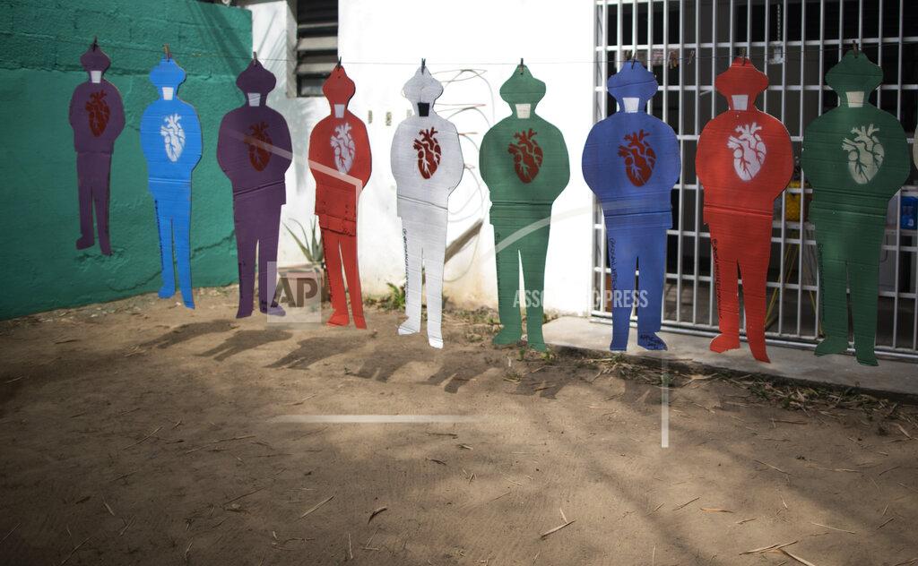 Ariana Cubillos Cardboard silhouettes representing the late Venezuelan Dr. Jose Gregorio Hernandez, known as the "doctor of the poor, constructed by artist Susan Applewhite, hang from a clothesline in her backyard in Caracas, Venezuela, Saturday, April 24, 2021. Hernandez is set to be beatified by the Catholic church, a step towards sainthood, on April 30th in the Venezuelan capital. (AP Photo/Ariana Cubillos)