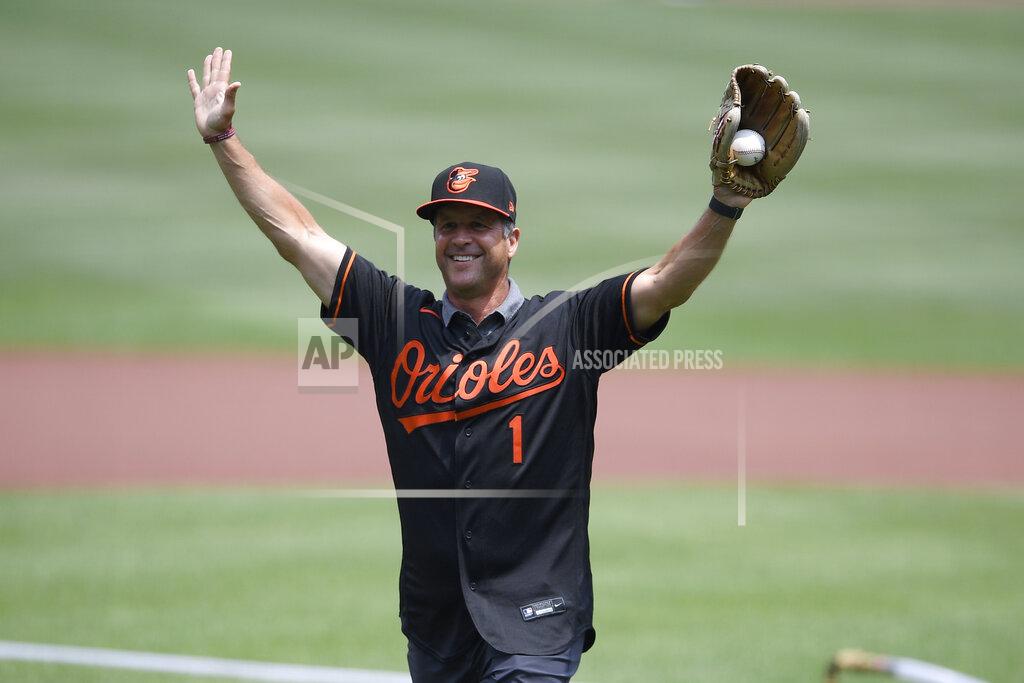 Nick Wass Baltimore Ravens head football coach John Harbaugh reacts after he threw out the ceremonial first pitch using a football before a baseball game between the Baltimore Orioles and the Washington Nationals, Sunday, July 25, 2021, in Baltimore. (AP Photo/Nick Wass)