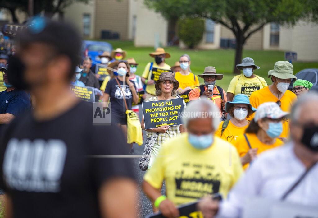 Ricardo B. Brazziell A group of people make a stop at Good Hope Church in Round Rock, Texas, Wednesday, July 28, 2021 during a march from Georgetown, Texas to the Texas State Capitol in downtown Austin. Church leaders and former Democratic congressman Beto O'Rourke are leading the nearly 30-mile voting rights march in Texas. The walk began with nearly 100 participants in suburban Austin and will is scheduled to end this weekend at the state Capitol. The march is the latest effort by Democrats to keep up the pressure over voting rights at a time when the prospects of action from Congress is fading. (Ricardo B. Brazziell/Austin American-Statesman via AP)