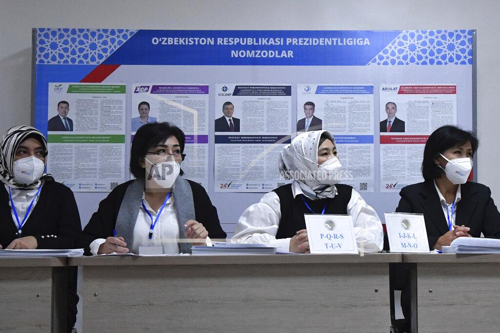 Uncredited Members of an election commission wait for voters at a polling station during the presidential election in Tashkent, Uzbekistan, Sunday, Oct. 24, 2021. President Shavkat Mirziyoyev, who has relaxed many of the policies of his dictatorial predecessor but has made little effort at political reform, is expected to win a new term by a landslide against weak competition in an election Sunday. (AP Photo)