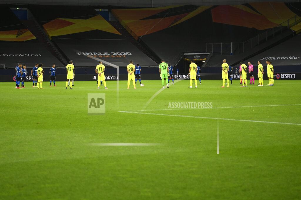 Ina Fassbender Players observe a moment of silence for the victims of the COVID-19 pandemic before the Europa League round of 16 soccer match between Inter Milan and Getafe at the Veltins-Arena in Gelsenkirchen, Germany, Wednesday, Aug. 5, 2020. (Ina Fassbender, Pool Photo via AP)