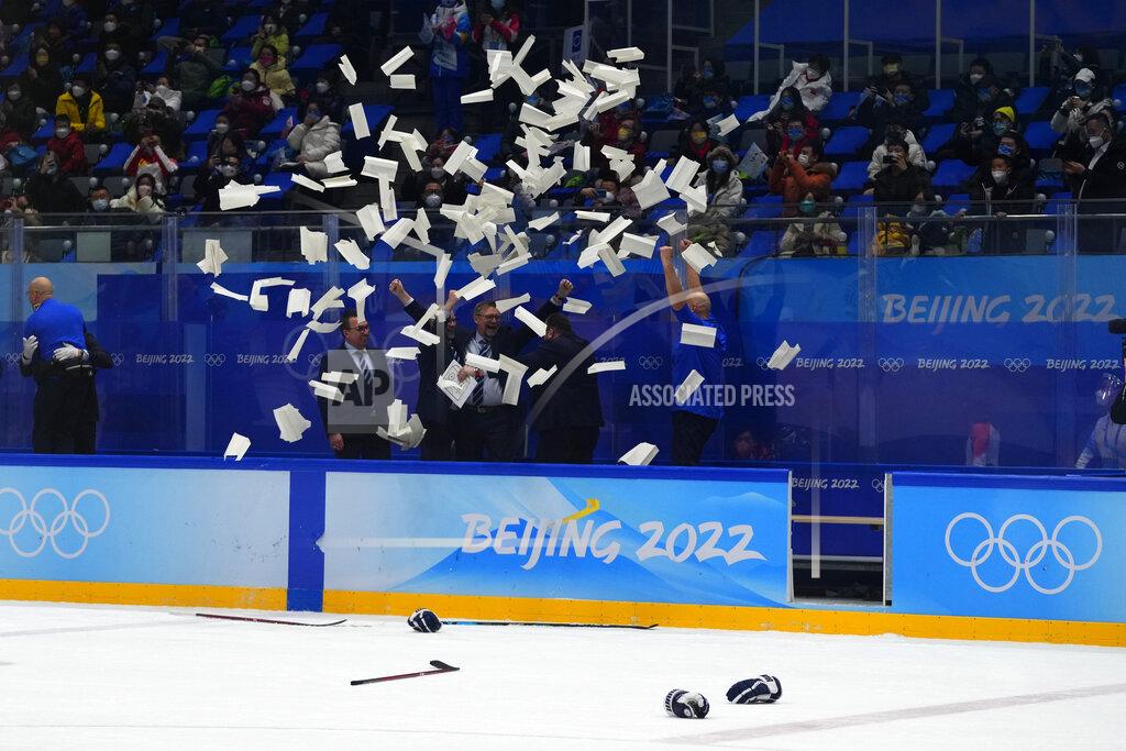 Petr David Josek White papers are tossed in the air near Finland coaches after defeating the Russian Olympic Committee in the men's gold medal hockey game at the 2022 Winter Olympics, Sunday, Feb. 20, 2022, in Beijing. (AP Photo/Petr David Josek)