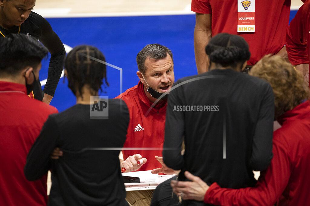 Rebecca Droke Louisville head coach Jeff Walz, center, talks to the team during a timeout in the first half of an NCAA college basketball game against Pittsburgh, Thursday, Feb. 18, 2021, in Pittsburgh. (AP Photo/Rebecca Droke)