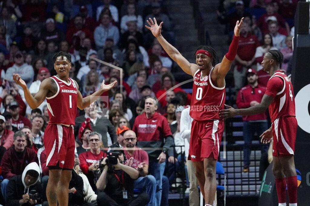 Sue Ogrocki Arkansas guards JD Notae (1), Stanley Umude (0) and Davonte Davis (4) react to an official's call in the second half of an NCAA college basketball game against Oklahoma, Saturday, Dec. 11, 2021, in Tulsa, Okla. (AP Photo/Sue Ogrocki)