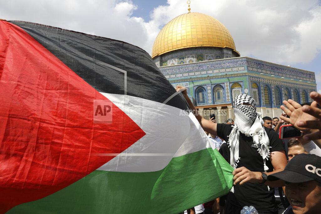 Mahmoud Illean Protesters hold a Palestinian flag during a protest celebrating the six Palestinian prisoners who recently tunneled out of the Gilboa Prison, after Friday prayers at the Dome of the Rock Mosque in the Al Aqsa Mosque compound in in the Old City of Jerusalem, Friday, Sept. 10, 2021. (AP Photo/Mahmoud Illean)