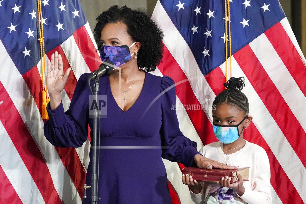 Elise Amendola Former Boston City Council President Kim Janey, 55, is sworn in as Boston's new mayor at City Hall while her granddaughter, Rosie, holds a Bible, Wednesday, March 24, 2021, in Boston. Janey, who is the city's first female and first person of color to take the office, replaces Marty Walsh who resigned Monday evening to become President Joe Biden's labor secretary. (AP Photo/Elise Amendola)